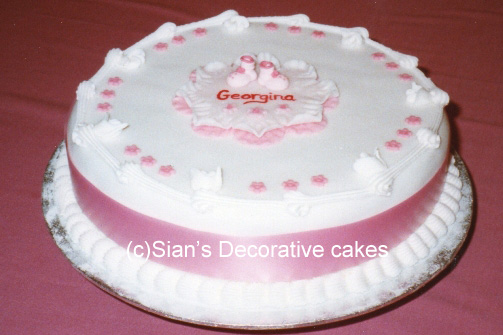 Baptism cake with pink bib